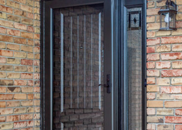 rustic bronze storm door with glass door in front