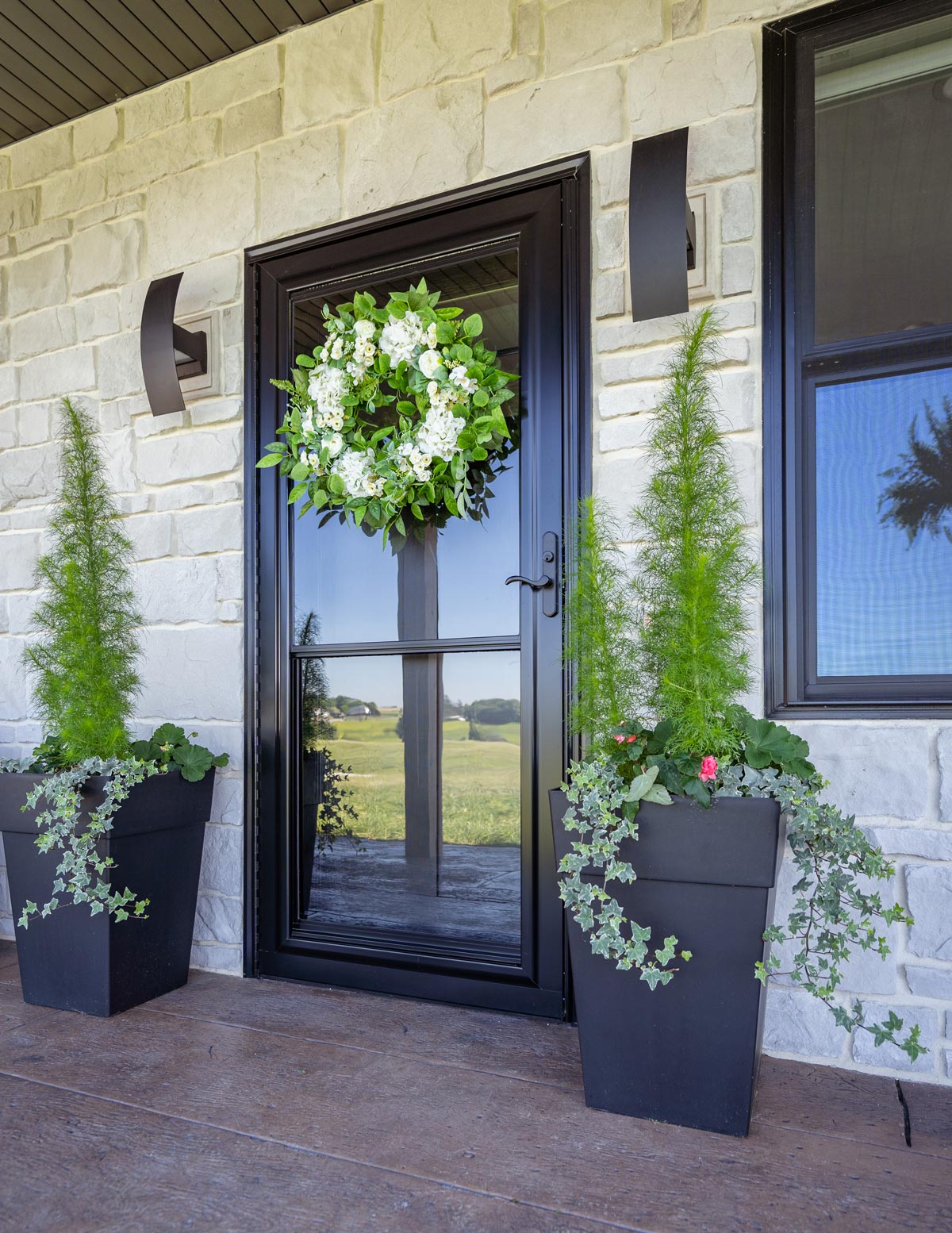 solid glass storm door with wreath